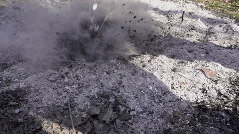Water pours in slow motion on an extinct fire Stock Footage 153256018