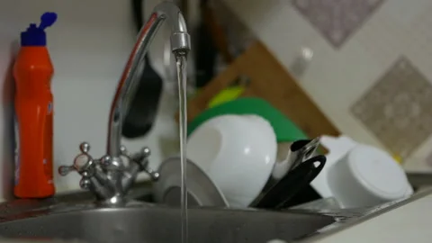 Water pours from a tap in the kitchen Video stock 134540552