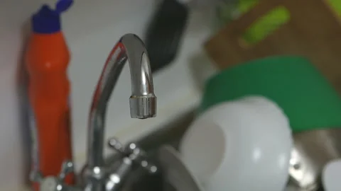 Water pours from a tap in the kitchen Stock Footage 134542656