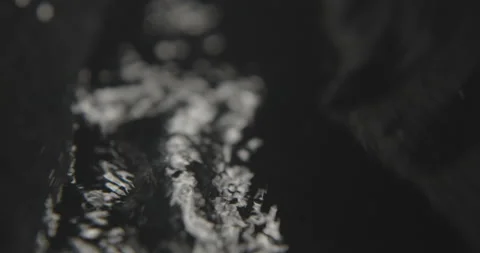 Water pours through pipe into splash of darkness Stock Footage 139719341