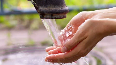 Water pours onto your hands. Environment concept.  Stock Footage 159908265