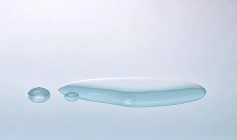 Water puddle from drops spilled onto surface. Stock Photos