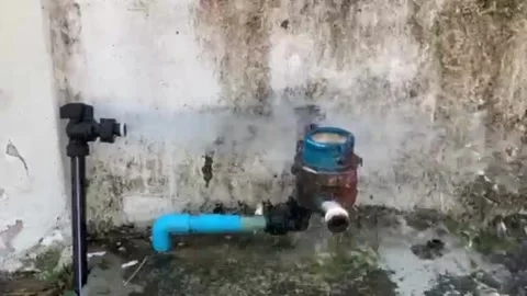 Water pump nozzle was broken in front of someone's house Stock Footage 149286059