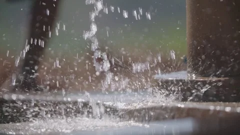 Water from a pump splashing on the ground Stock Footage 74390446