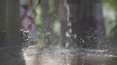 Water from a pump splashing on the ground Stock Footage 74390491
