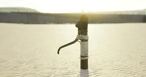 Water pump standing alone in an arid landscape during sunset Stock Illustration