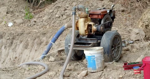 The water pump is working.The water pump uses an old diesel engine. Stock Footage 274752767