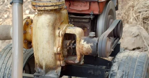 The water pump is working.The water pump uses an old diesel engine. Stock Footage 283484661