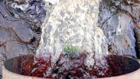 Water pumping out of the pipe, sewer pollutes a lake, top view Stock Footage 90470321