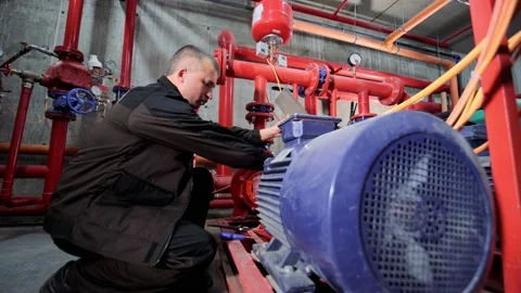 A water pumping station engineer repairs the water supply compressor engine. Stock Footage 158421734