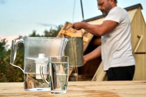 Water purification using a water filter jug at the countryside in summer Stock Photos