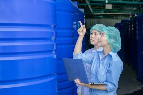 Water quality control officer engineer team inspect water tanks in beverage.. Stock Photos