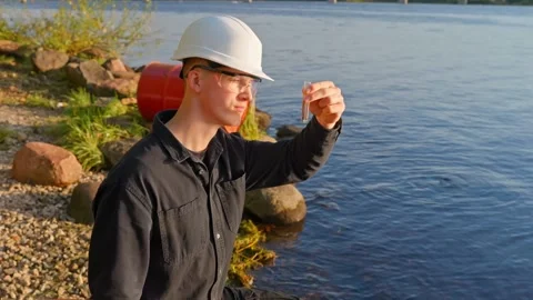 Water Quality Testing for Environmental Pollution by River Stock Footage 321933806