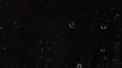 Water rain drops falling down on glass over black background, 4K design element Stock Footage 145509146