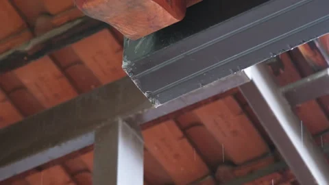 Water rain drops overflow on eaves house roof Stock Footage 243438034