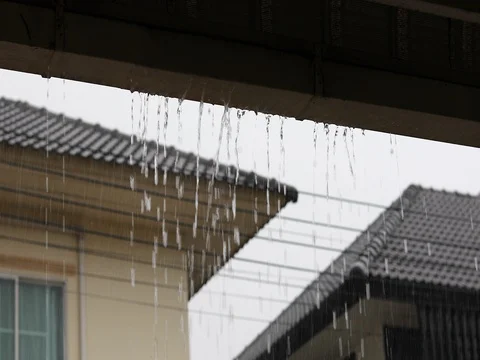 Water rain drops overflow on gutter roof house Stock Footage 80336925