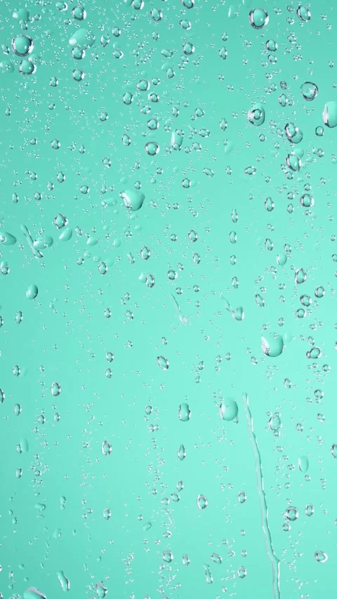 Water rainfall, rain drops falling on window glass over turquoise background Stock Footage 307305044