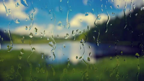 Water rainfall, rain drops falling on window glass over a lake background. Stock-Footage 321536934