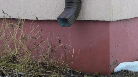 Water is raining out of the gutter on ground Stock Footage 147856706