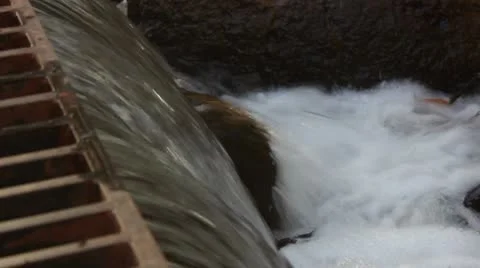Water Rapidly Flows through a Storm Drain Vídeo Stock 8955474