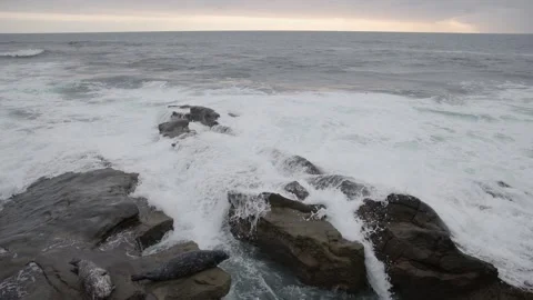Water rapids and white waves slap against rocky tide pools Stock Footage 244251055