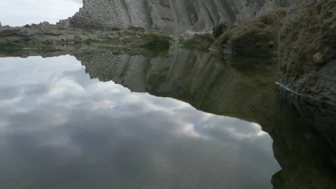 Water reflecions of ocean cliffs in Spain 4K Stock Footage 137710316