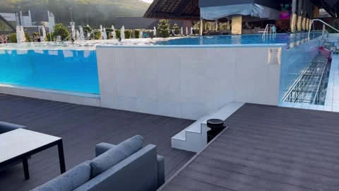 Water reflecting sunlight in an infinity pool at a resort Stock Footage 284990288