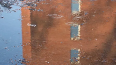 Water Reflection of Building Facade in Puddle with Ripples, After rain scene Stock Footage 230459813