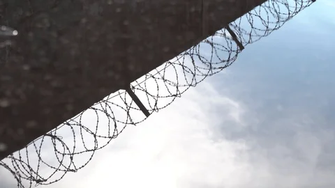 The water reflection of a concrete wall with barbed wire Stock Footage 129792847