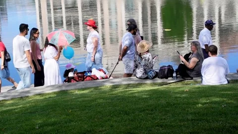 Water reflection, people sitting, walking by lake water, summertime Canada Stock Footage 338209910