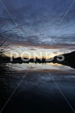 Water reflection sunset Stock Photos