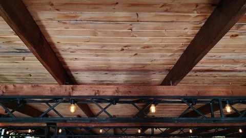 Water reflections dancing on wooden ceiling beams. Video stock 334860908