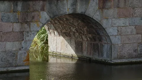 Water reflections under an old stone bridge arch. Stock Footage 167165257