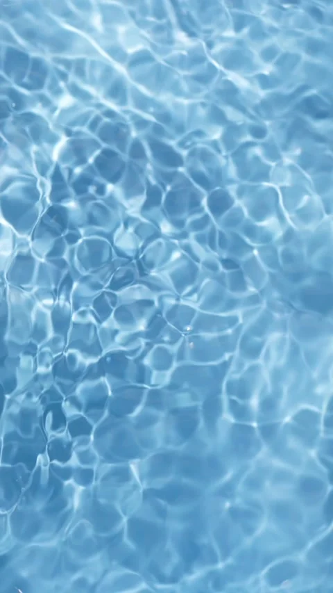 Water reflects sunlight while creating patterns in a swimming pool during the Stock Footage 323622333