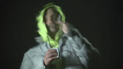The water reflects a Young guy drinking hot tea or coffee from a red mug, Smokin Stock Footage 120577837