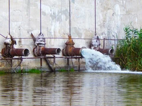 Water released from the dam through pipes into the canal Stock Photos