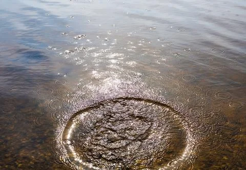 Water ripple effect from splashing liquid droplet Stock Photos