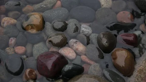Water rising and falling over pebbles Stock Footage 44213339