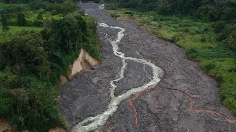 Water river on hard cold lava river near an erupted Sinabung volcano Stock Footage 168245004