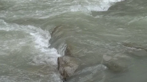 Water of a river jumping a rock Stock Footage 100893840