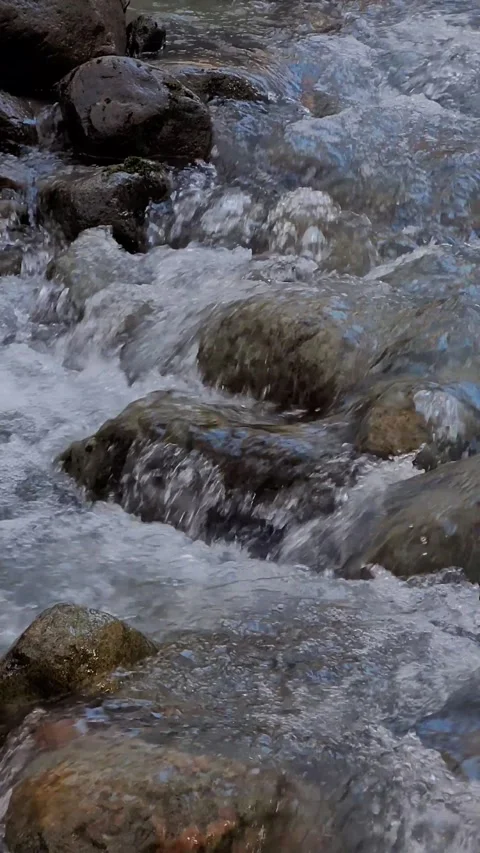 Water running between the rocks in the stream. 4K Stock Footage 271200041