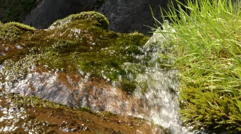 Water running down a cliff close-up Stock Footage 8623978