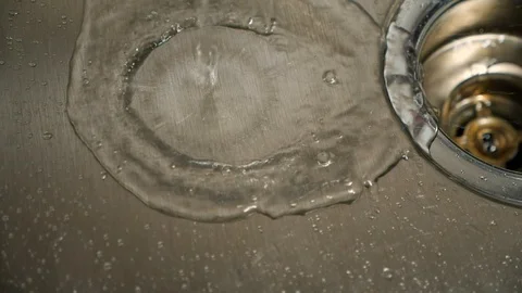 Water running down a kitchen sink drain in slow motion Stock Footage 127198982
