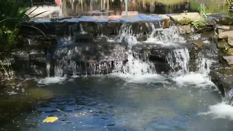 Water Running Down Over The Rocks Into A Pool Of Water 库存影片 132129395