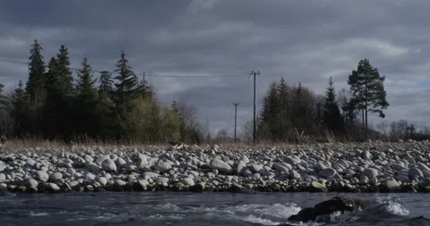 Water running fast passing rocks in mountain river. Stock Footage 147633729