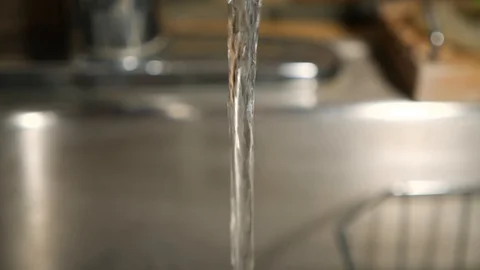 Water running from a kitchen faucet Stock Footage 127656455