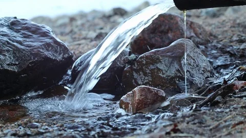 Water running out of drain pipe into lake, Finland 스톡 동영상 108649083