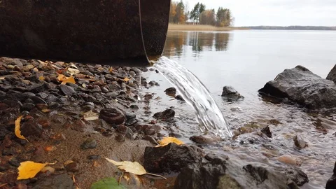 Water running out of drain pipe into lake, Finland Stock-Footage 118956330