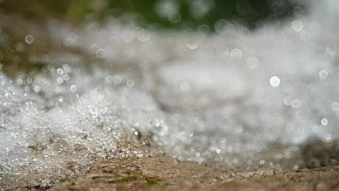 Water running over a rock in front of a pool (slow motion) Video stock 219635939