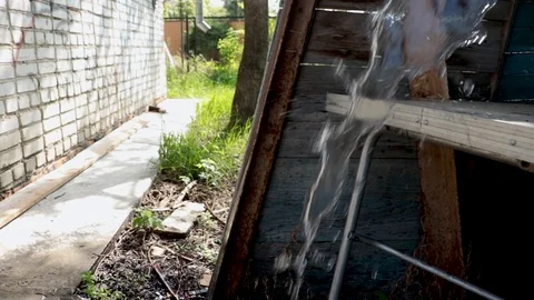 Water running on the table in the outbuilding. Stock Footage 110772448